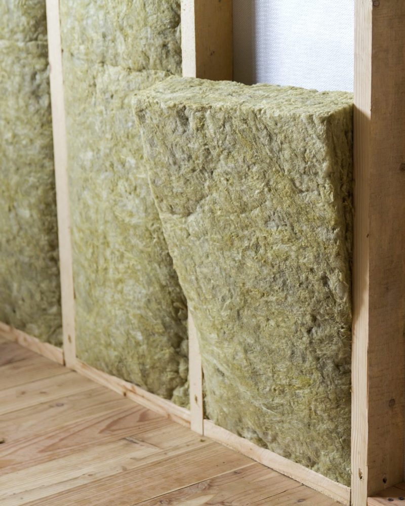 Wooden frame for future walls insulated with rock wool and fiberglass insulation staff for cold barrier. Comfortable warm home, economy, construction and renovation concept.